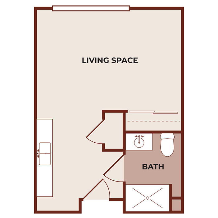 Floor plan of a studio apartment showing a large living space, a bathroom with a toilet, sink, and shower, and a small kitchen area along one wall near the entrance.