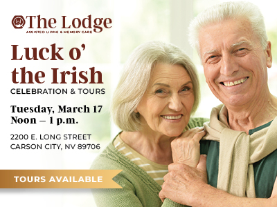 Smiling elderly couple standing close together, promoting a "Luck o' the Irish" celebration and tours event at The Lodge in Carson City, Nevada, on Tuesday, March 17, from noon to 1 p.m. Tours available.